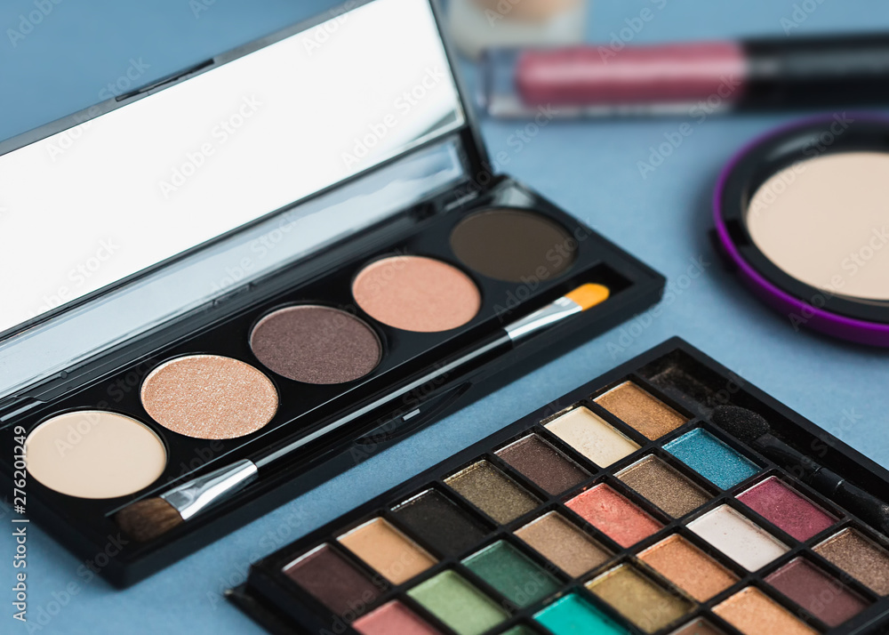 Set of decorative cosmetics, makeup tools on grey background Set of decorative cosmetics, makeup tools on grey background