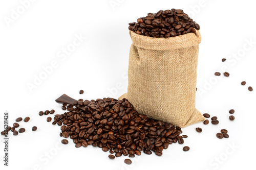 Coffee beans. Jute burlack sack with roasted coffee beans and coffee spatula, isolated on white background.