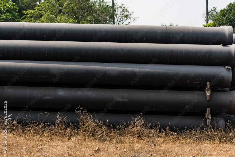 ductile iron pipes stocked in open space of a rural village store yard. ductile iron pipes stocked in open space of a rural village store yard.