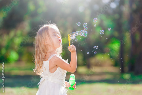 girl white dress  soap bubble blower