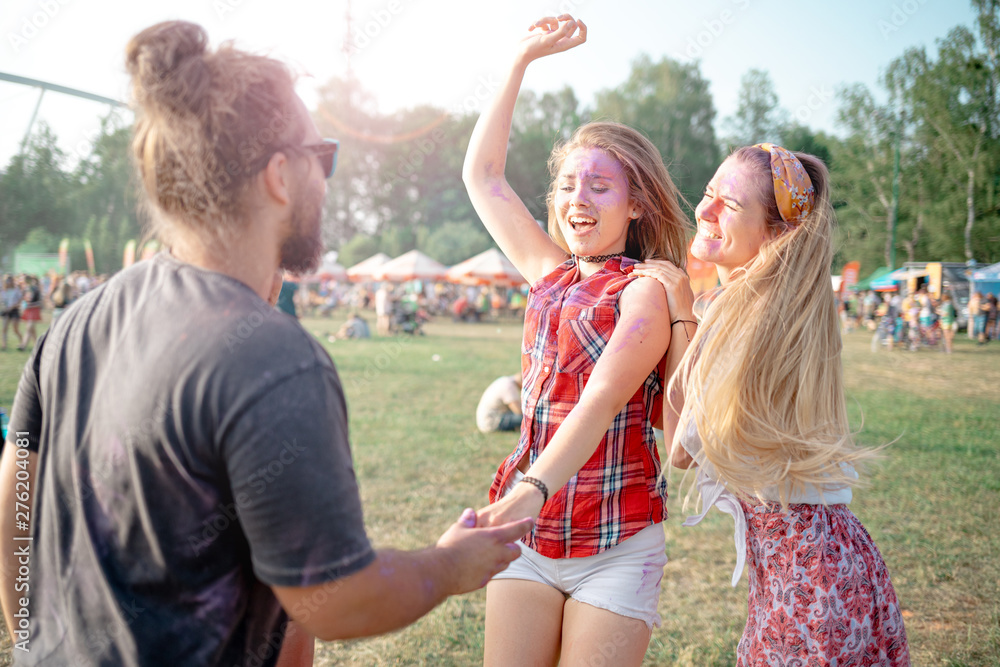 Fototapeta premium Friends covered with color powder having fun at holi festival