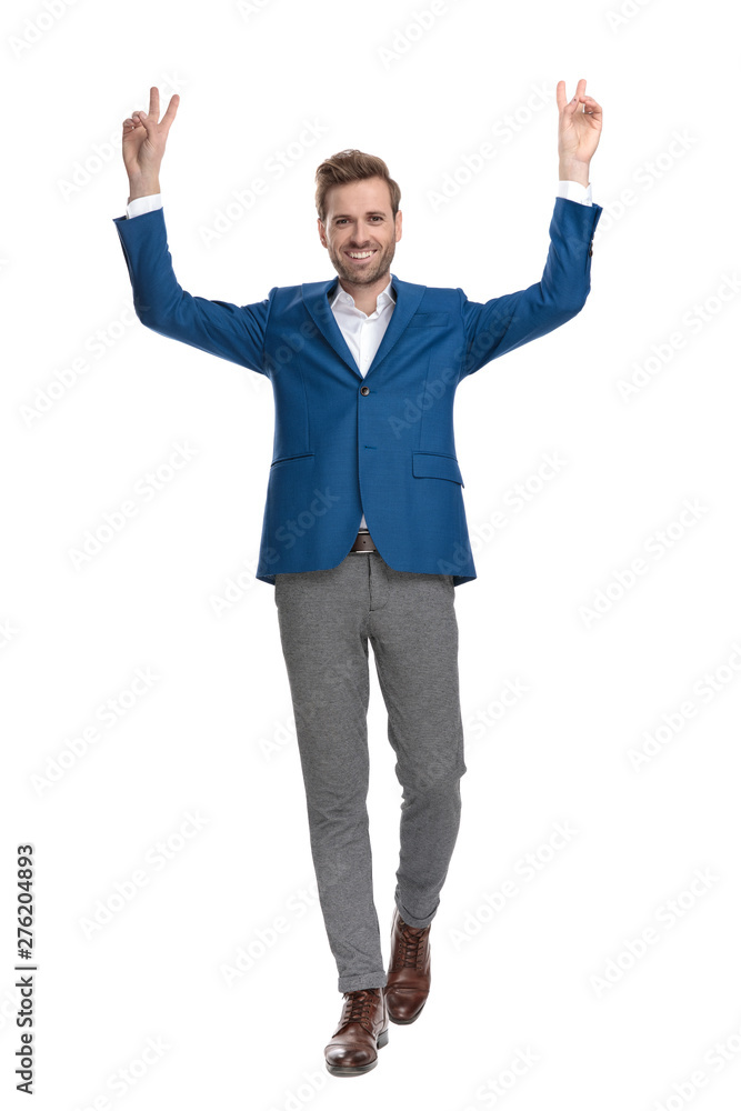Positive casual man walking and gesturing peace Positive casual man walking and gesturing peace