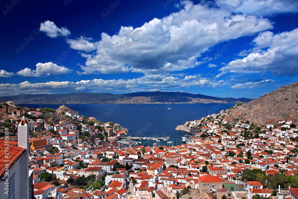 Panoramic view of the port of Hydra town, Hydra island, Attica, Greece. Photo taken from Kiafa, the old part of the town, In the background the coast of Argolis, Peloponnese. Panoramic view of the port of Hydra town, Hydra island, Attica, Greece. Photo taken from Kiafa, the old part of the town, In the background the coast of Argolis, Peloponnese.