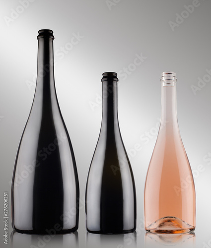 three champagne bottles on grey background photo