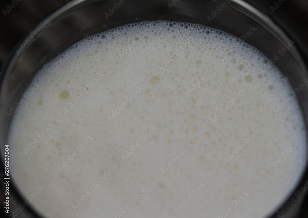 Self made vanilla milkshake in glass on reed background