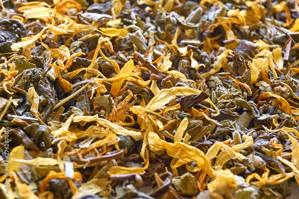 Herbal tea closeup. Multi coloured dried herbal tea leaves background with selective focus.   