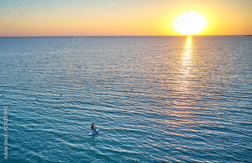 Canvas Print a man with a child swimming on SAP surfing