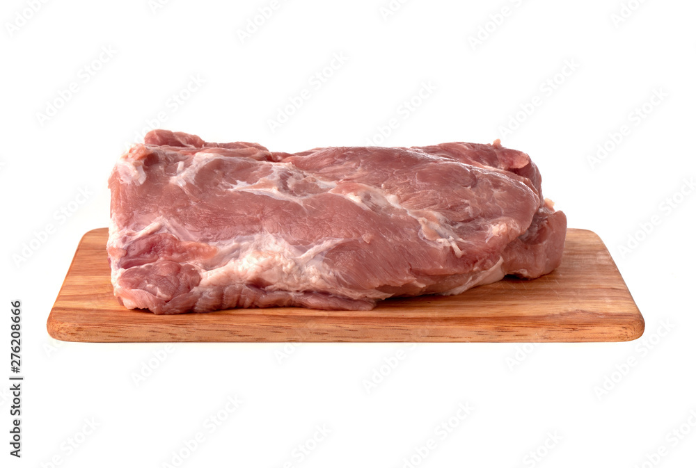 A piece of meat on a white background. Raw piece of pork on a wooden board. A piece of meat on a white background. Raw piece of pork on a wooden board.