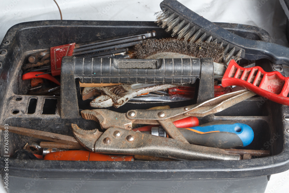 Fototapeta premium Plastic toolbox with pliers, screwdriver, brush, drills and wrench