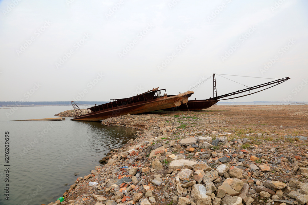 Simple sand dredger by river bank