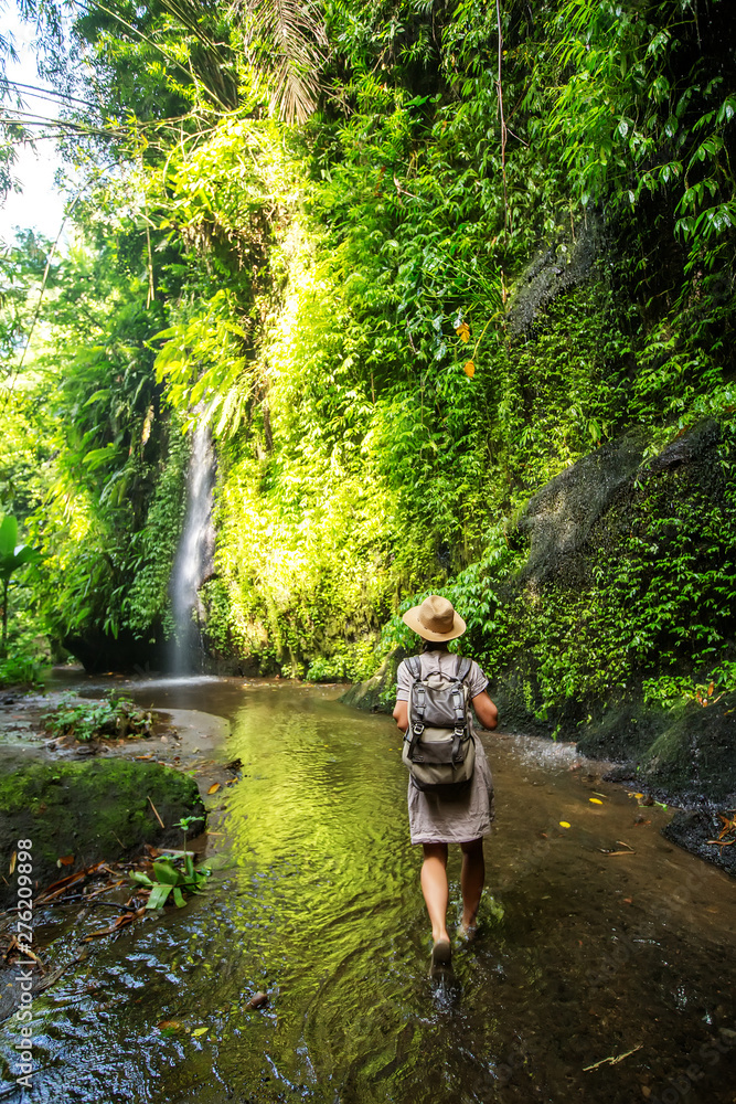 Woman near waterfal on Bali, Indonesia Woman near waterfal on Bali, Indonesia