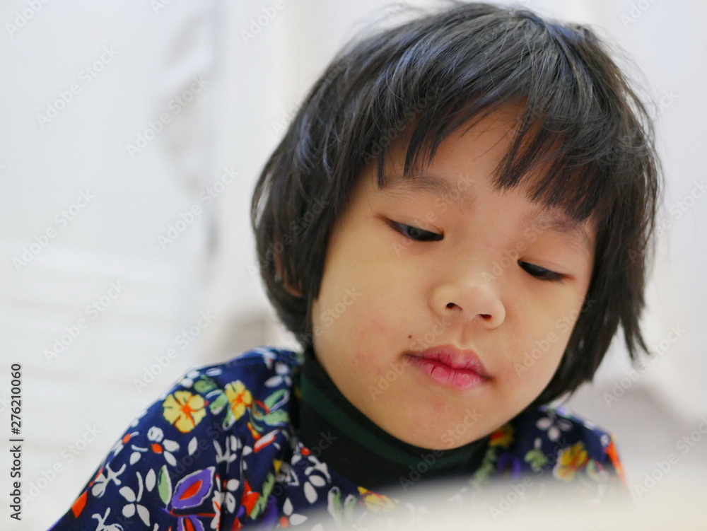 Little baby girl's face, 3 years old, while watching / staring at a smartphone