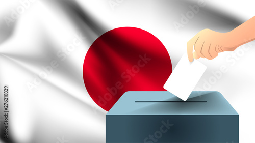 Male hand puts down a white sheet of paper with a mark as a symbol of a ballot paper against the background of the Japan flag, japanese the symbol of elections