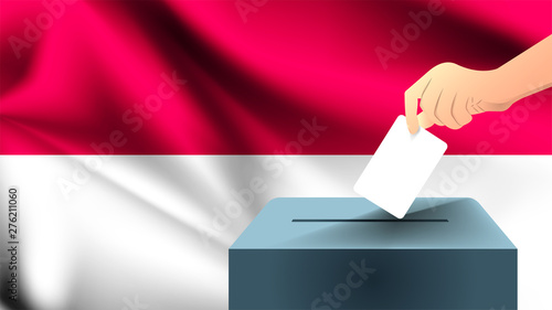 Male hand puts down a white sheet of paper with a mark as a symbol of a ballot paper against the background of the Indonesia flag, Indonesia the symbol of elections