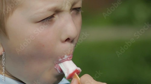 child licks ice cream,Close-up boy licking ice cream in a delicious summer