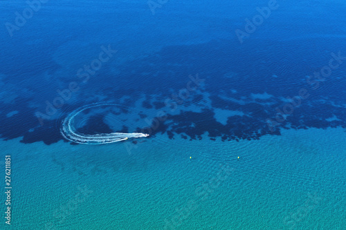 Aerial view of speed boat in motion. Water transportation and summer leisure time activity. photo