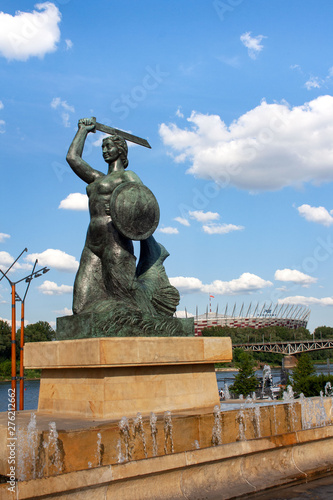  Mermaid statue in Warsaw in Powiśle, in the background the Vistula and the National Stadium