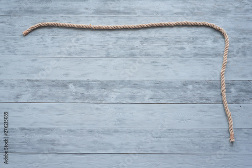 Rope on the wooden board background.