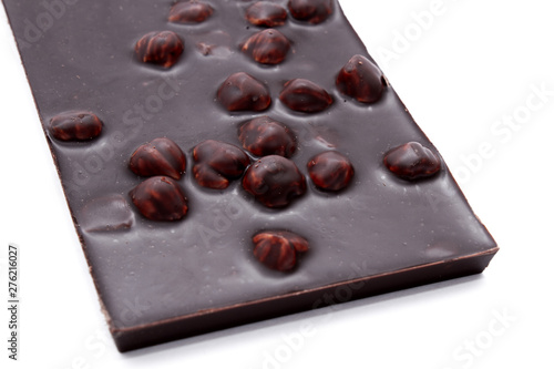 Black chocolate bar with nuts isolated on white background