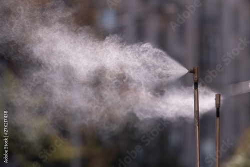 Spray nozzle outdoor air conditioning system outdoor cafe climate in hot weather. Street climate control water jets spray cooling water. Nozzle for street conditioning