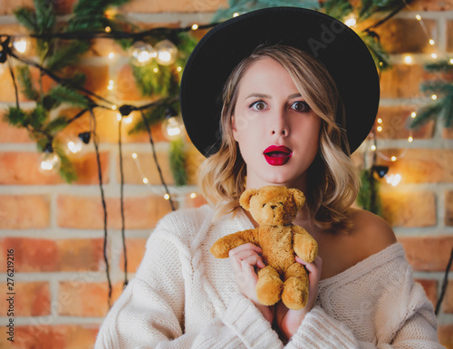 woman with teddy beartoy and Christmas lights photo