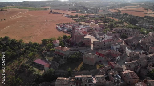 Aerial view of Torres del Rio, Spanish town along Camino de Santiago or Way of Saint James. Urban landscape with buildings and old church in Navarre region, Spain seen from drone flying in sky photo