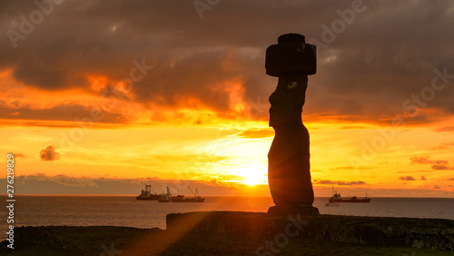 COPY SPACE: Stunning golden morning sunbeams shine on ancient moai in Ahu Tahai photo