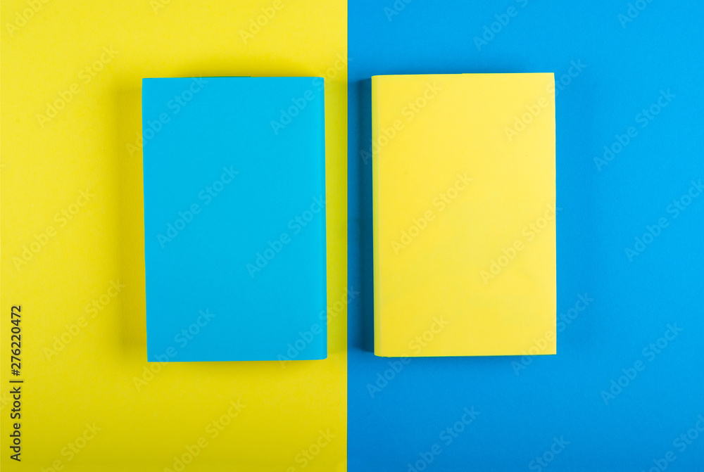 Blue and yellow books Mock up on a yellow-blue background. Flat Lay, Copy space, space for text, top view Blue and yellow books Mock up on a yellow-blue background. Flat Lay, Copy space, space for text, top view