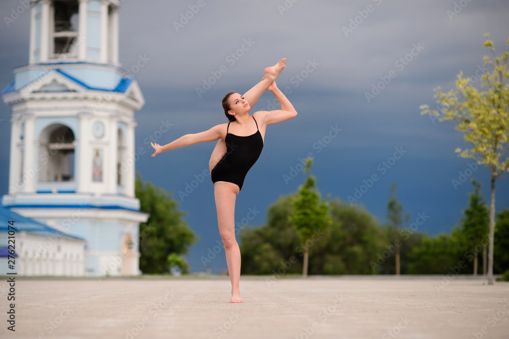 Girl gymnast, performs various gymnastic and fitness exercises.