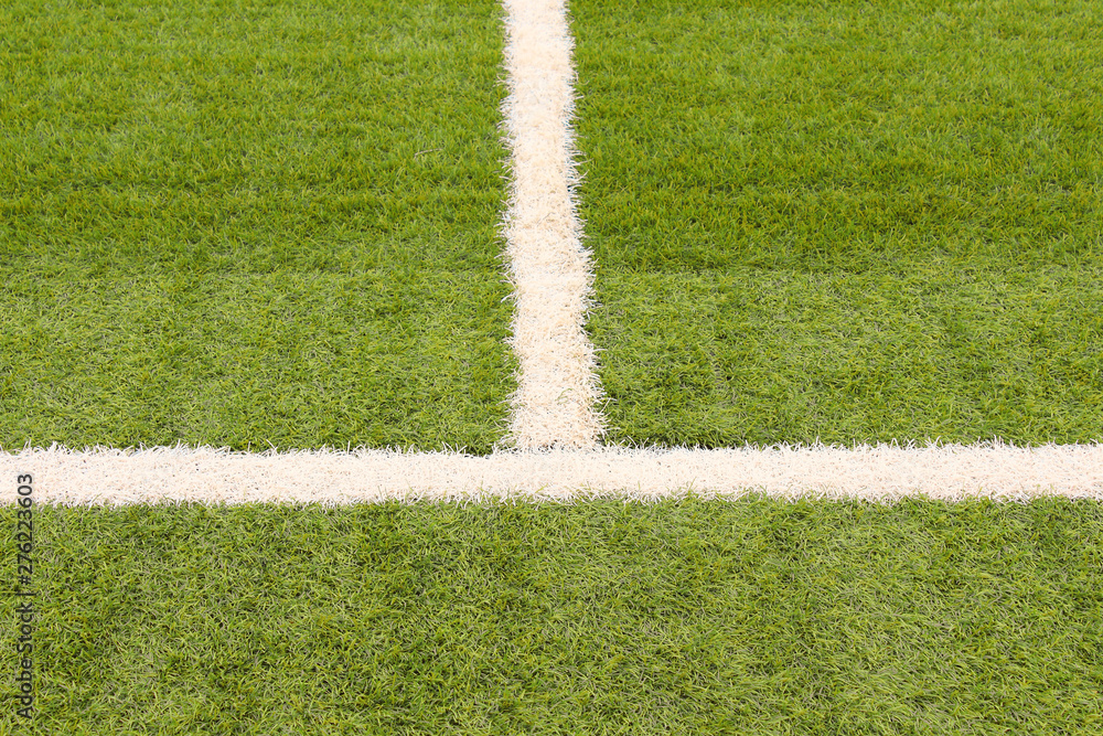 Artificial grass on the football field. Close-up. Background. Texture.