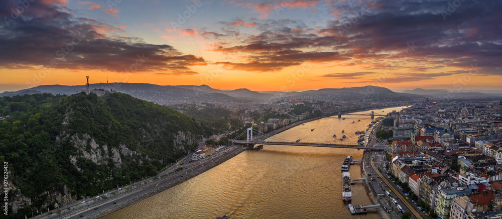 Fototapeta premium Budapest, Hungary - Aerial panoramic skyline view of Budapest with Elisabeth Bridge, Szechenyi Chain Bridge, Buda Castle Royal Palace, Gellert hill and Statue of Liberty and a dramatic colorful sunset
