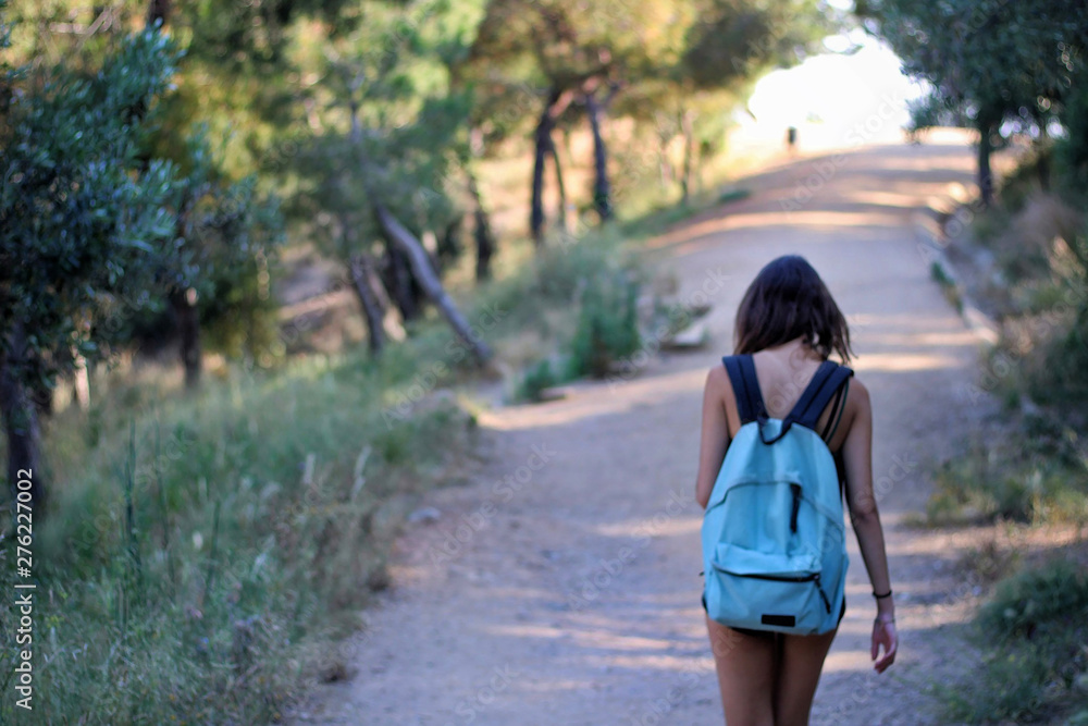Woman with backpack walking up the mountain. Woman with backpack walking up the mountain.