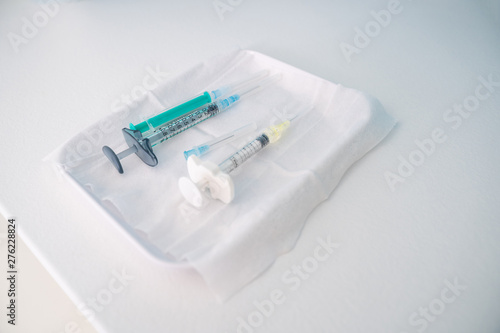 Syringes with liquids in them placed on the tray