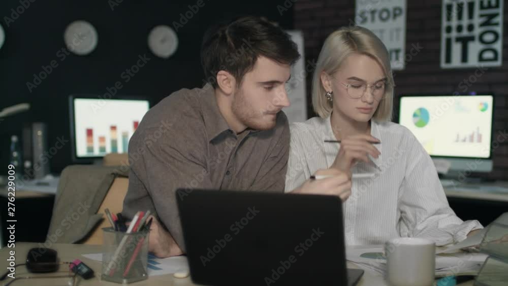 Business man and business woman working together with financial document Business man and business woman working together with financial document
