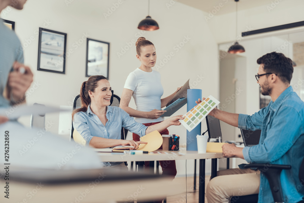 Glad women and man working with preliminary design Glad women and man working with preliminary design