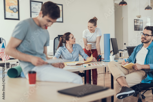 Cheerful colleagues are planning corporate strategy together