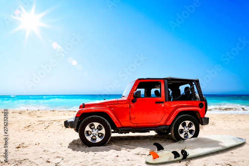 Summer red car on beach and sea landscape with blue sky and sun . 