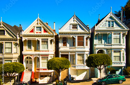 San Francisco residential street with The Painted Ladies, rows of victorian wooden houses at Alamo Square. 