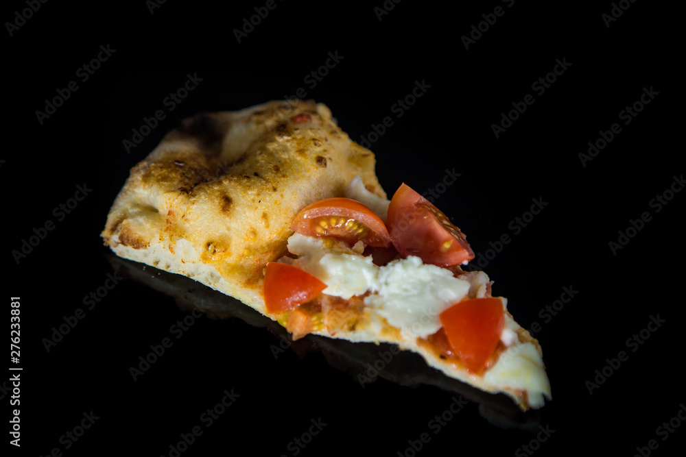 top view closeup slice of pizza with tomatoes and mozzarella
