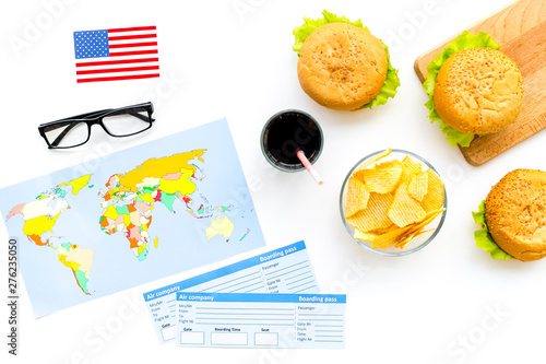 Burger  chips  map  tickets and usa flag for gastronomical tourism to America on white background top view