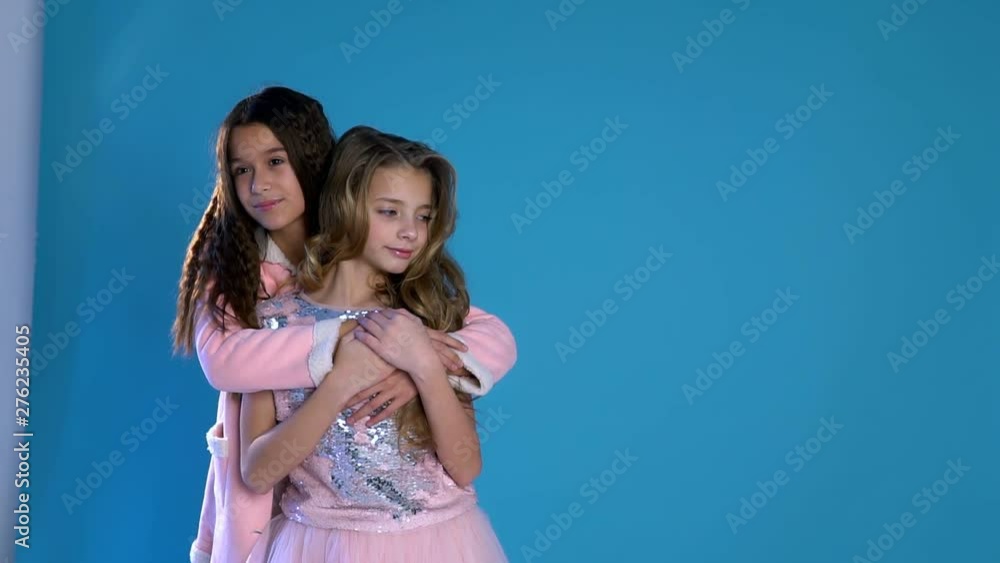 Two fashionable girls laugh cuddling Two fashionable girls laugh cuddling