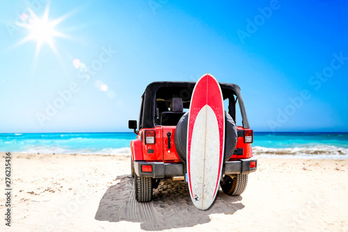 Summer red car on beach and sea landscape with blue sky and sun .  © magdal3na