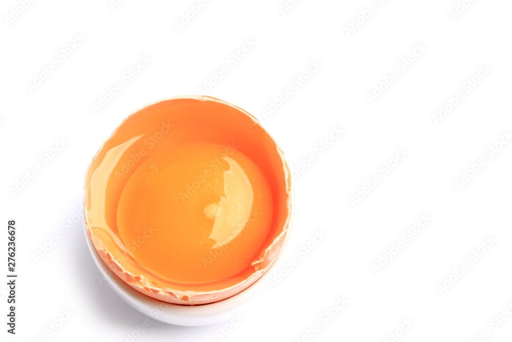 half raw chicken egg with yolkcom isolated on white background