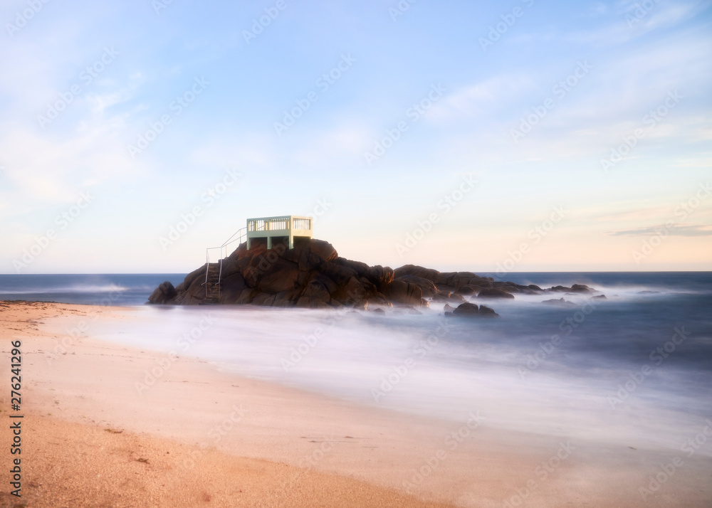 View point or gazebo over the rocks on a beach in Vila do Conde, Portugal, at sunset.