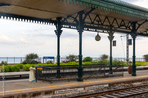 Obraz na płótnie Taormina, Italy - May 14, 2018: Taormina Giardini Naxos railway station (Stazione di Taormina-Giardini), small railway station situated in 1 km away well below the Taormina old town, Sicily, Italy w salonie