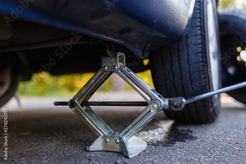 Closeup of metal keeps the car Jack to change a flat tire