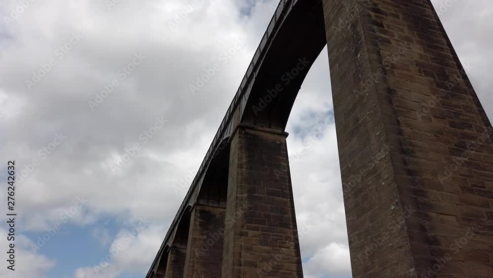 Pontcysyllte Aqueduct arch bridge canal waterway crossing. Slow low angle dolly looking up to arches. Pontcysyllte Aqueduct arch bridge canal waterway crossing. Slow low angle dolly looking up to arches.