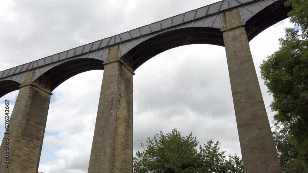 Pontcysyllte Aqueduct arch bridge canal waterway crossing. Low angle push in tilt up view under arches. Pontcysyllte Aqueduct arch bridge canal waterway crossing. Low angle push in tilt up view under arches.