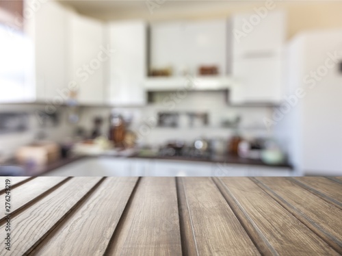 Fototapeta Naklejka Na Ścianę i Meble -  Worn table and blur with bokeh kitchen background