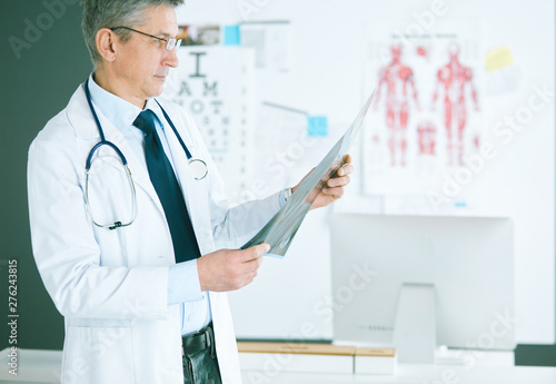 Male doctor writes notes on the clipboard in the hospital